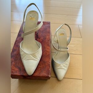 White closed toe pumps with elastic at back heel strap, size 9 Medium.